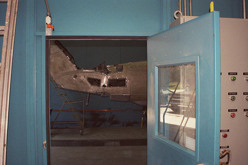 Click to enlarge Stripped Helicopter in the Blast Booth Viewed from the Control Room