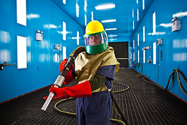 Blast Room Operator in Protective Gear